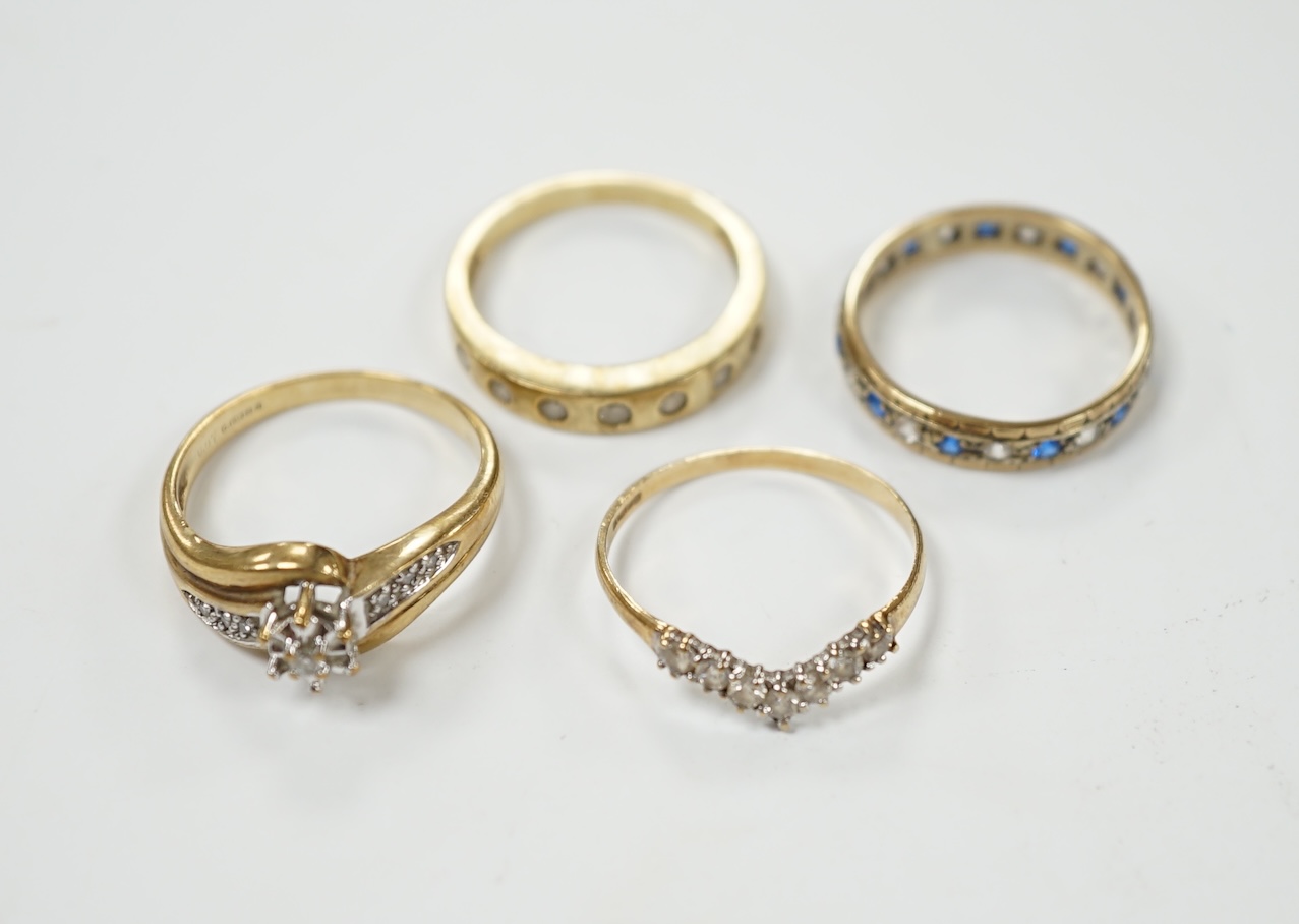 Two modern 9ct gold and diamond set rings and a 9ct gold, simulated diamond set chevron shaped ring and one other 9ct and paste set band, gross weight 9 grams. Condition - poor to fair